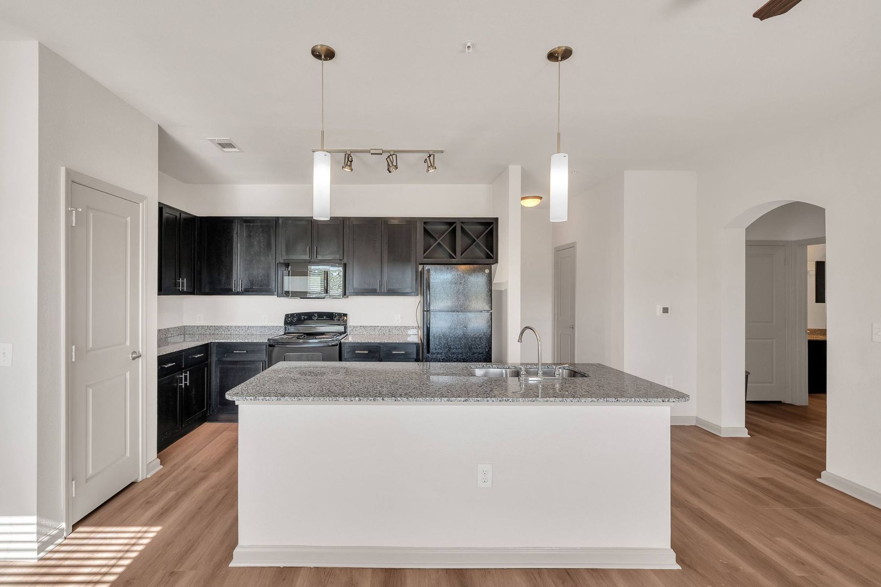 Luxury apartment kitchen with stainless steel appliances, granite countertops, and lots of storage space